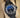 angled view of a custom stealth matte black PVD Rolex Deepsea James Cameron edition showing the gradient blue to black face on a presentation cushion