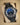 angled view of a custom stealth matte black PVD Rolex Deepsea James Cameron edition showing the gradient blue to black face on a presentation cushion