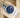 An angled top-down view of an Oystersteel Rolex Datejust 36 126200 blue dial watch resting on a beige leather display cushion