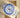 An angled top-down view of an Oystersteel Rolex Yacht-Master II 116680 blue ceramic watch resting inside its beige leather presentation cushion